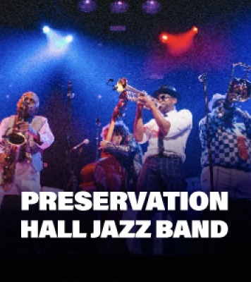 Several men playing jazz instruments and bright lights shining down with Preservation Hall Jazz Band text at the bottom